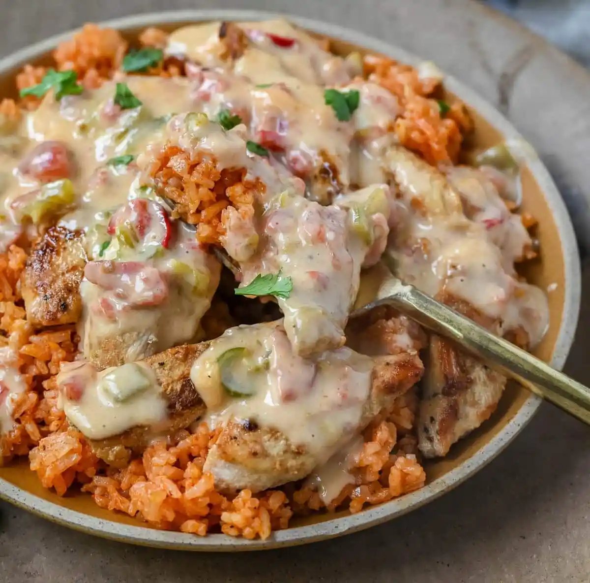 This Queso Smothered Chicken is a comforting, flavor-packed meal that makes everyone at the table ask for seconds — Pollo con Queso is it. This dish brings together juicy sautéed chicken, homemade Spanish rice, and a rich, creamy queso sauce made from scratch. A hearty, cheesy, restaurant-style dish you can make right at home — and better than takeout.