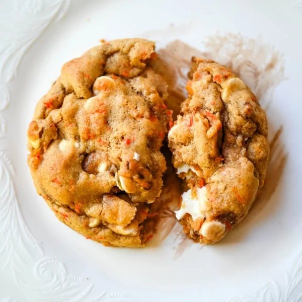 These Levain Bakery Carrot Cake Cookies are everything you love about carrot cake in a soft, thick cookie. Made with shredded carrots, warm spices, white chocolate chips, dried apricots and pecans, they are rich, flavorful, and perfectly chewy. A delicious spring dessert that’s easy to make at home!