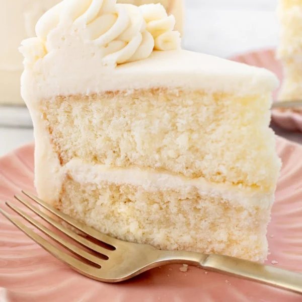 The best homemade vanilla cake recipe with vanilla bean buttercream frosting. If you’re looking for the best homemade vanilla cake recipe, this is it! This moist and fluffy vanilla cake is easy to make from scratch using simple ingredients. Perfect for birthdays or celebrations. This white cake recipe features a light, airy crumb and the most tender texture. This is a bakery-worthy dessert!