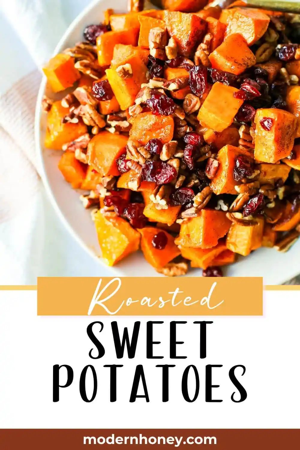 Roasted Sweet Potatoes with Cinnamon Maple Drizzle and tossed with dried cranberries and pecans. The perfect Fall side dish recipe! These roasted sweet potatoes make a beautiful Thanksgiving side dish.