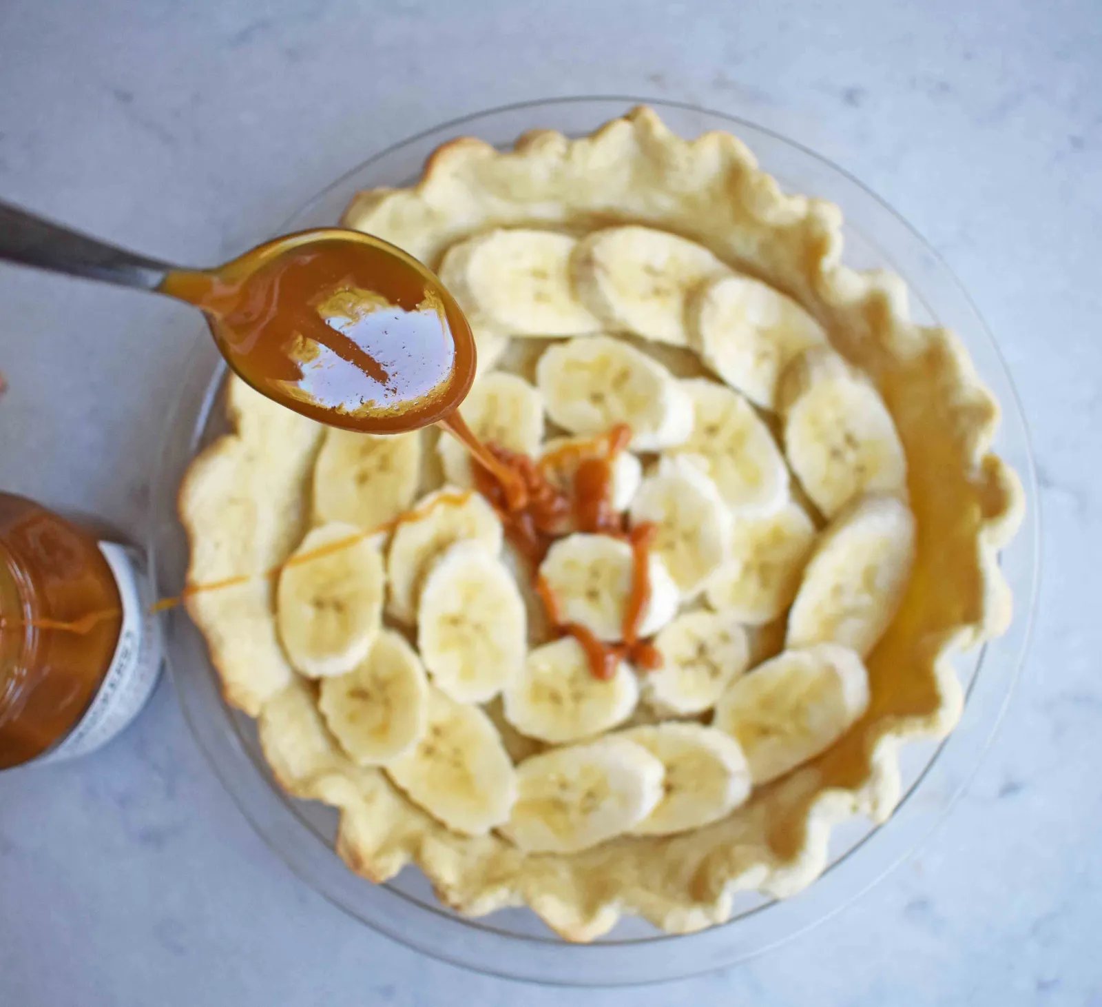 Salted Caramel Banana Cream Pie. Sweet Homemade Custard topped with fresh bananas, handcrafted salted caramel, and sweetened whipped cream all on a flaky, buttery crust.