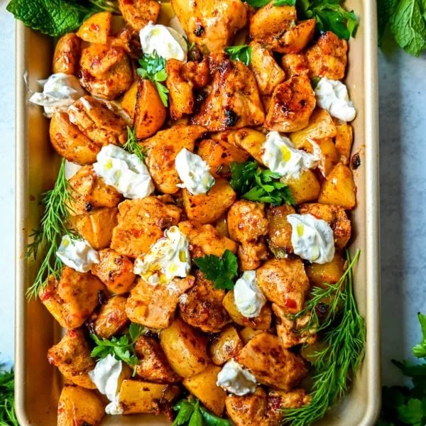 This Harissa Chicken and Roasted Potatoes recipe is a flavorful one-pan meal with juicy chicken breasts coated in a spicy harissa sauce and roasted with golden potatoes until perfectly crispy. A sprinkle of herbs at the end brings balance to this North African–inspired dish. It’s easy, satisfying, and the perfect simple weeknight dinner!