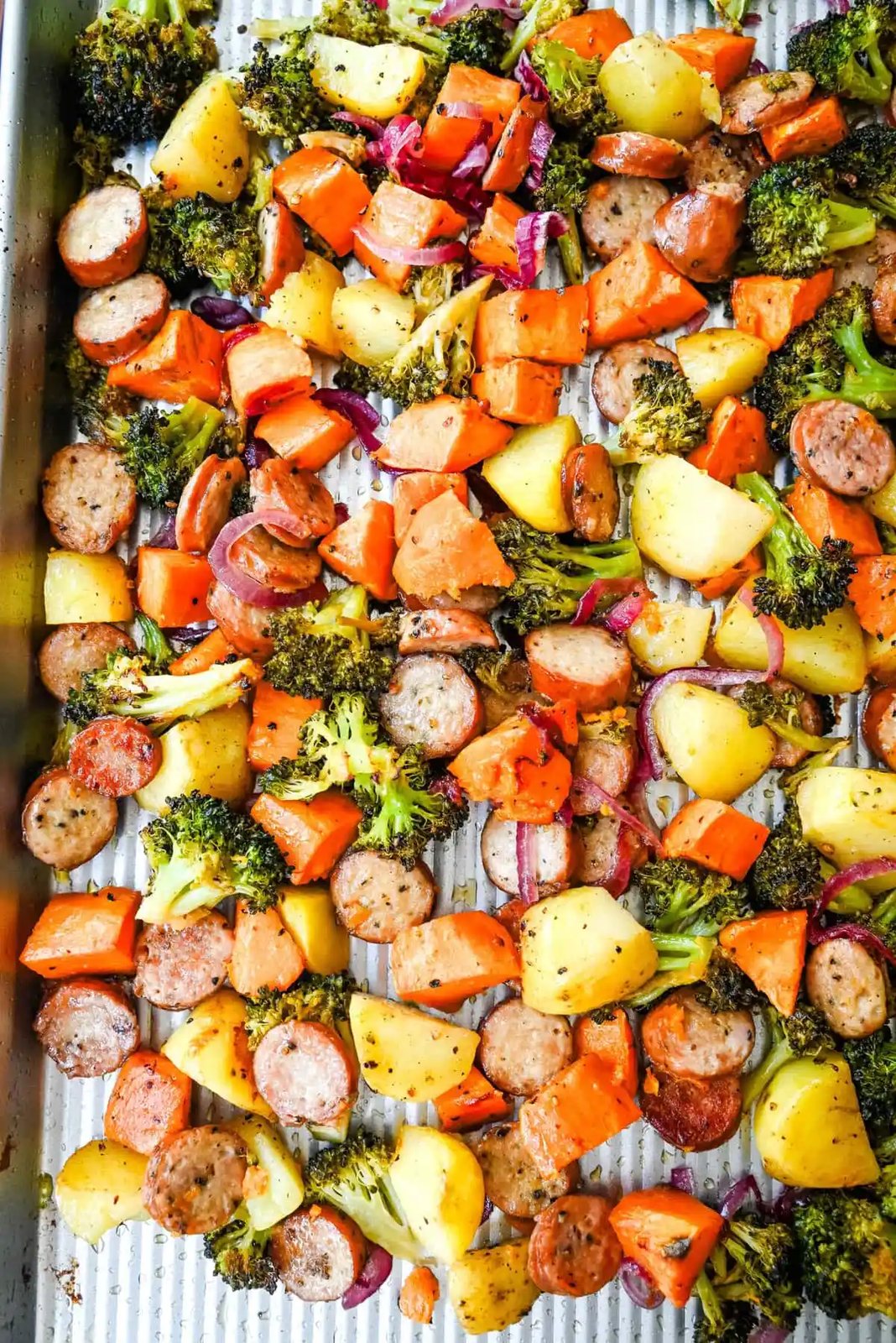 This Sheet Pan Chicken Sausage and Veggies Recipe is made with savory chicken sausage nestled between caramelized, crispy-edged vegetables, all roasted to perfection on a single sheet pan. It's quick, effortless, so delicious, and perfect for busy weeknights or cozy, family-style dinners.