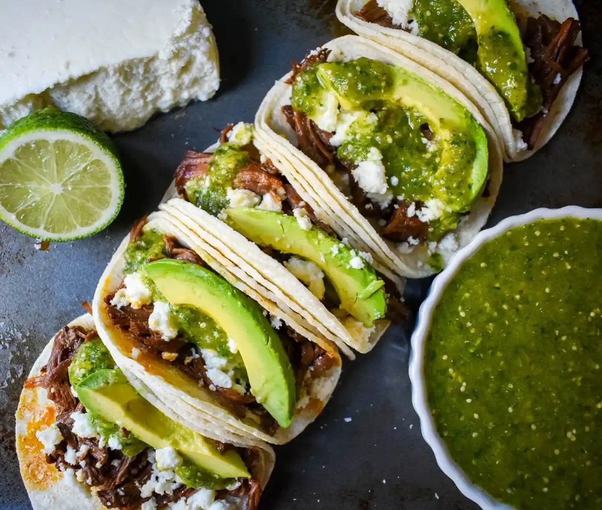 Slow Cooker Beef Barbacoa Tacos with Salsa Verde. These Barbacoa Beef Tacos with Tomatillo Salsa are made with slow cooked, Mexican spiced beef inside fresh corn tortillas and topped with homemade salsa verde, Mexican cheese, and fresh avocado. An easy and flavorful beef tacos recipe!