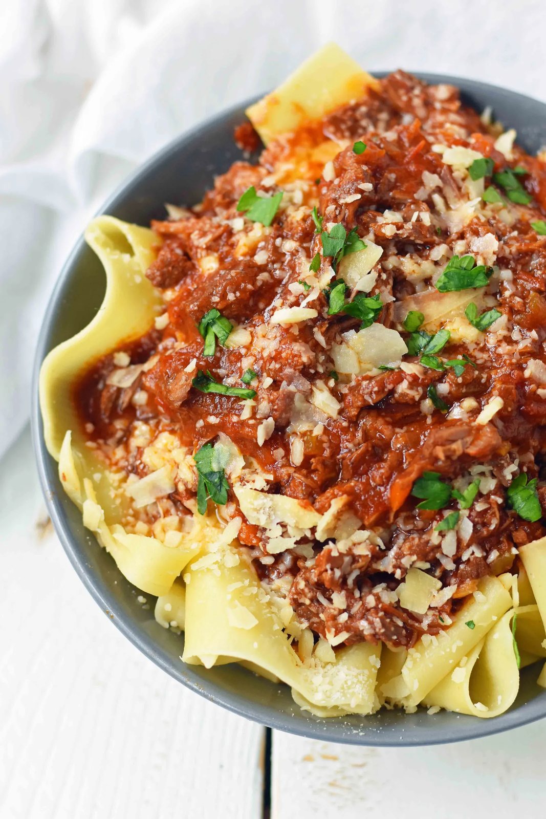 This braised shredded beef ragu with pappardelle pasta can be made in a slow cooker or instant pot pressure cooker. It makes the most tender, flavorful beef in a rich, velvety sauce. It is the ultimate comfort meal in a bowl! This Beef Ragu can be put on top of spiralized vegetables, mashed potatoes, or polenta for a gluten-free dinner. www.modernhoney.com