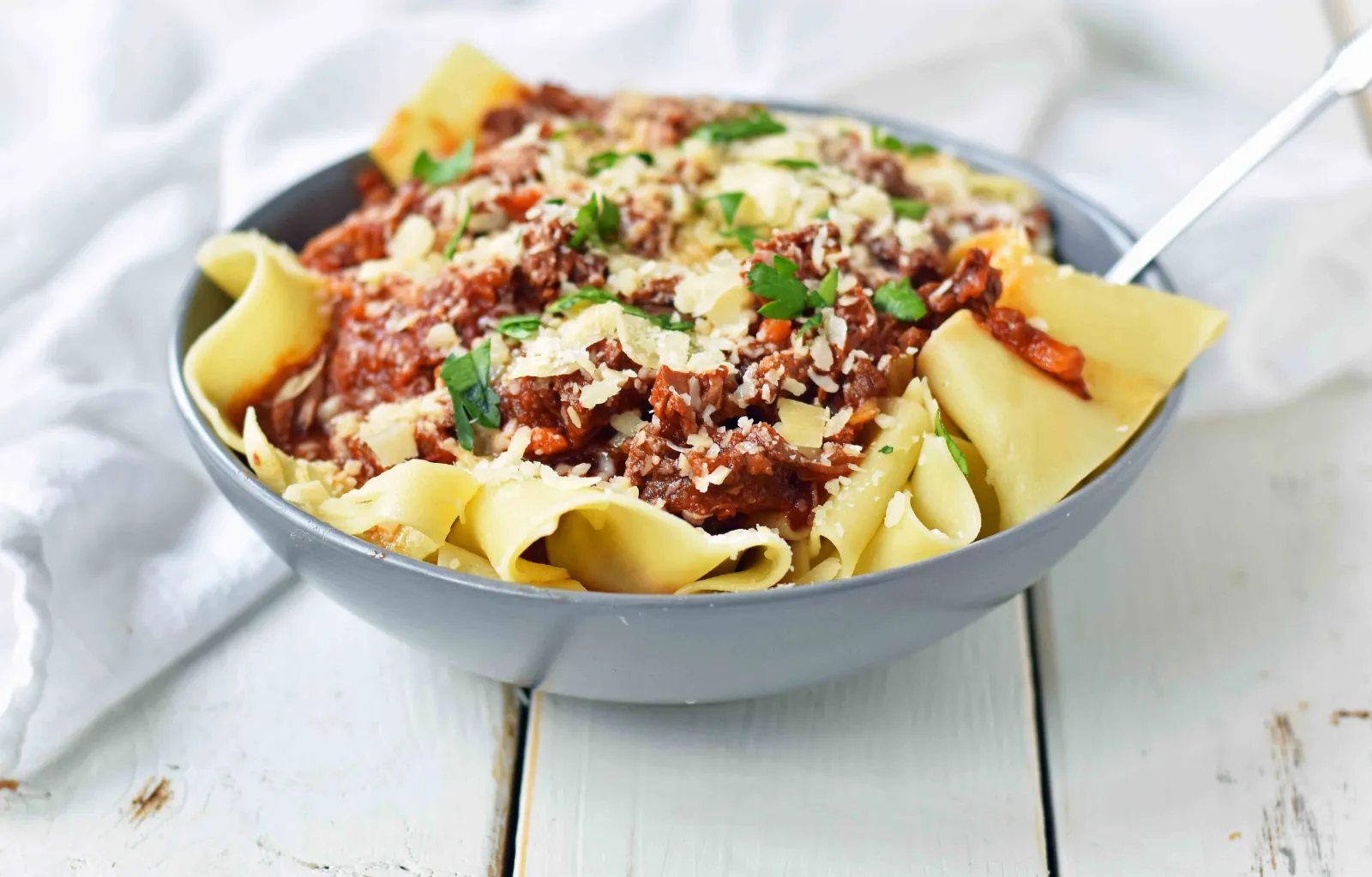 Slow Cooker Instant Pot Beef Ragu. This braised shredded beef ragu with pappardelle pasta can be made in a slow cooker or instant pot pressure cooker. It makes the most tender, flavorful beef in a rich, velvety sauce. It is the ultimate comfort meal in a bowl! This Beef Ragu can be put on top of spiralized vegetables, mashed potatoes, or polenta for a gluten-free dinner. www.modernhoney.com