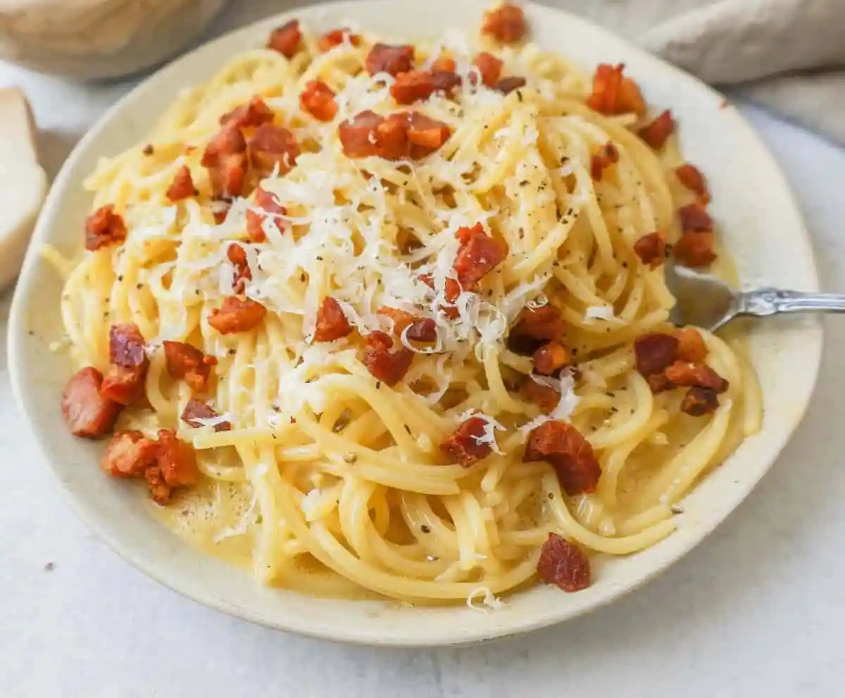 How to make the best spaghetti carbonara from scratch with only five ingredients. This homemade carbonara is made with nutty parmigiano reggiano cheese, pancetta, spaghetti, creamy egg yolks, and black pepper. This Italian carbonara is famous for good reason!