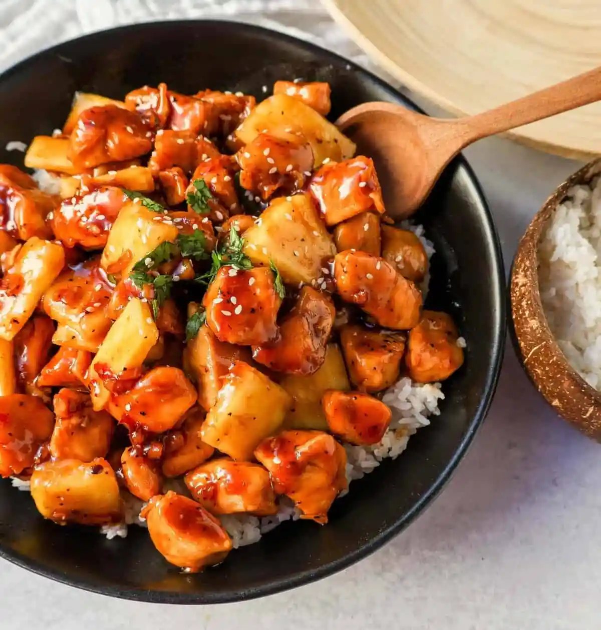 This Sticky Pineapple Chicken is made with chicken tossed in pineapple juice, sweet chili sauce, soy sauce, brown sugar, ginger, and fresh pineapple. This Hawaiian Chicken is perfectly sweet and sticky!