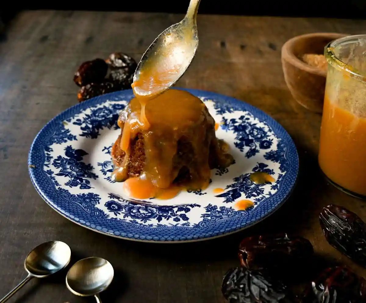 Sticky Toffee Pudding. A famous English dessert with a moist sponge cake covered in homemade caramel toffee sauce and vanilla ice cream. This is a beautiful Christmas dessert recipe.