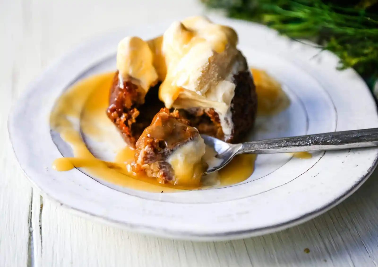 Sticky Toffee Pudding A famous English dessert with a moist sponge cake covered in a homemade caramel toffee sauce and vanilla ice cream. The perfect Christmas dessert or holiday dessert recipe. A Christmas traditional dessert. www.modernhoney.com #stickytoffeepudding #toffeepudding #stickypudding #datecake