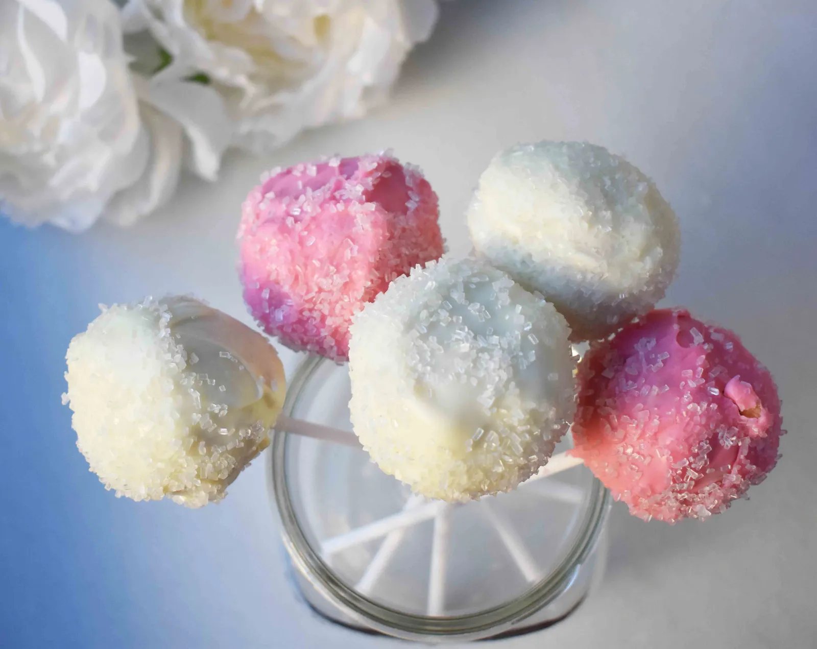 Strawberry Cheesecake Truffle Balls Cake Pops. Homemade yellow butter cake mixed with fresh strawberry cream cheese frosting. Then rolled in melted white melting wafers and sprinkled with sparkling sugar. www.modernhoney.com
