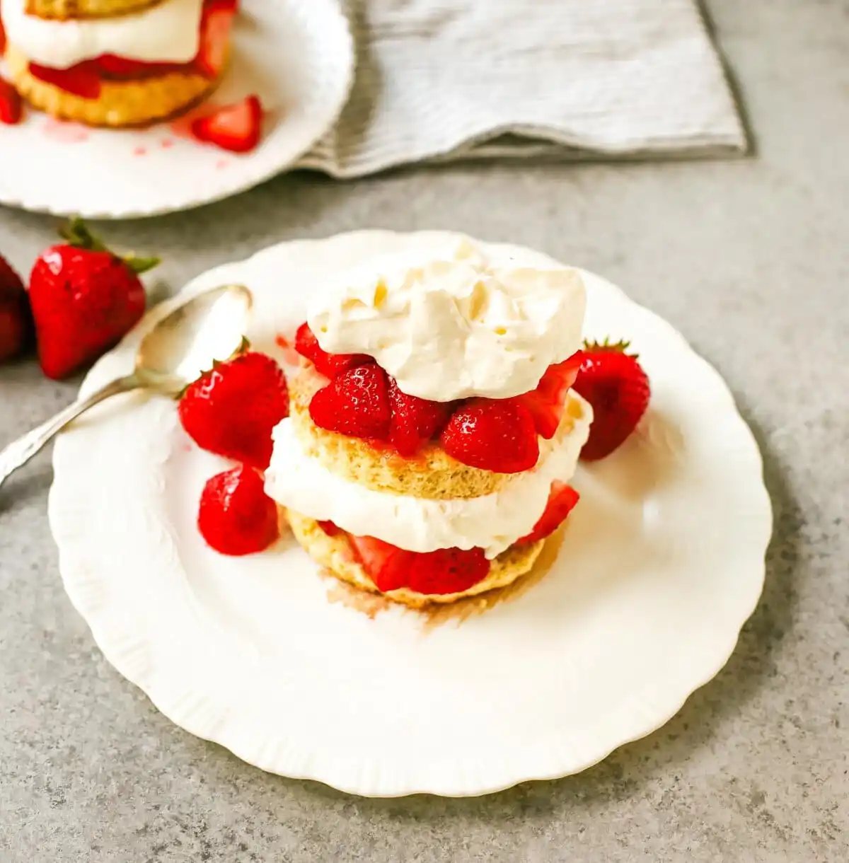 The Best Strawberry Shortcake with Homemade Sweet Biscuits, Sliced Strawberries, and Sweetened Whipped Cream. The sweet biscuits paired with sugared, syrupy strawberries, and fluffy whipped cream.
