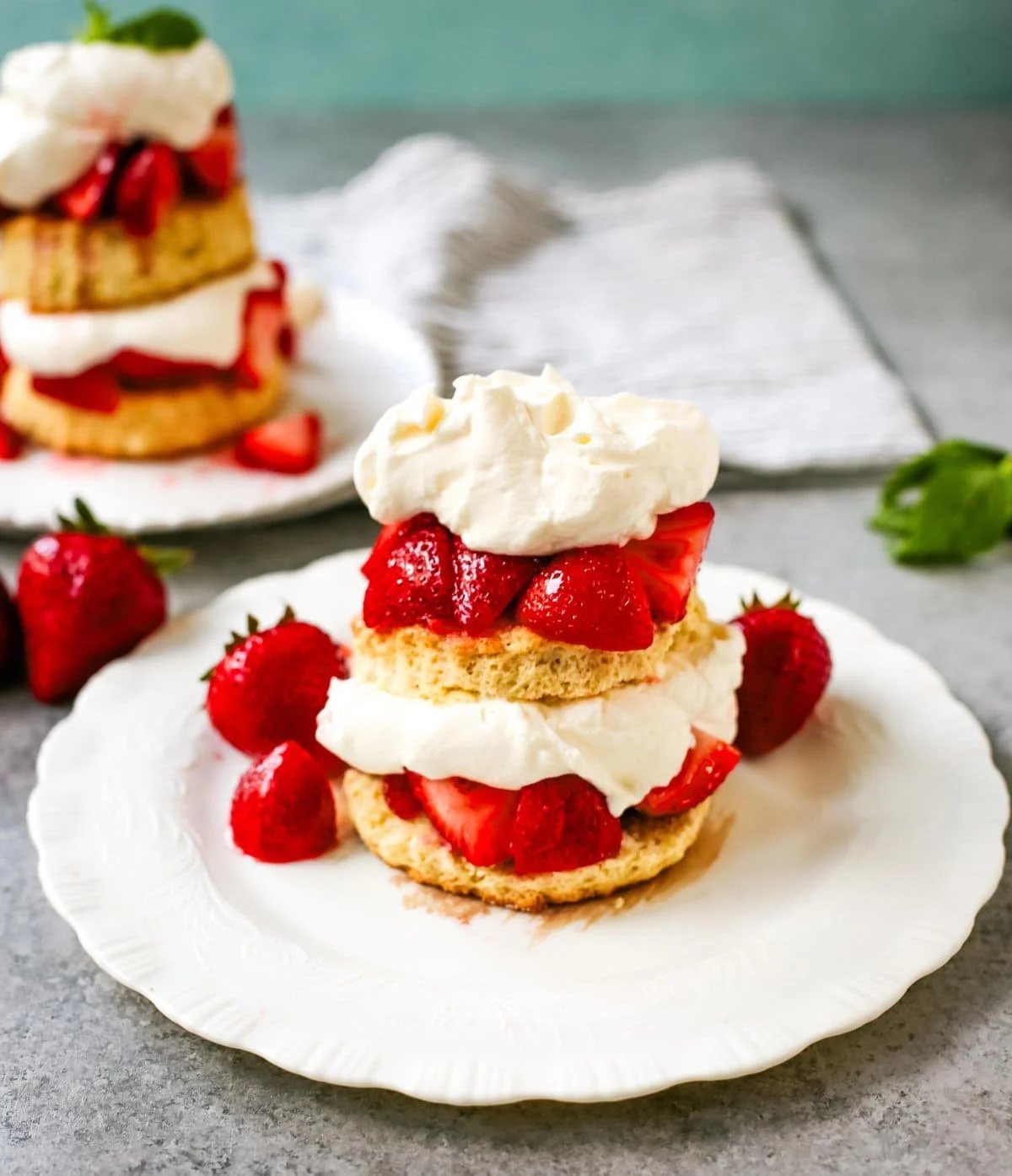 The Best Strawberry Shortcake with Homemade Sweet Biscuits, Sliced Strawberries, and Sweetened Whipped Cream. The sweet biscuits paired with sugared, syrupy strawberries, and fluffy whipped cream.