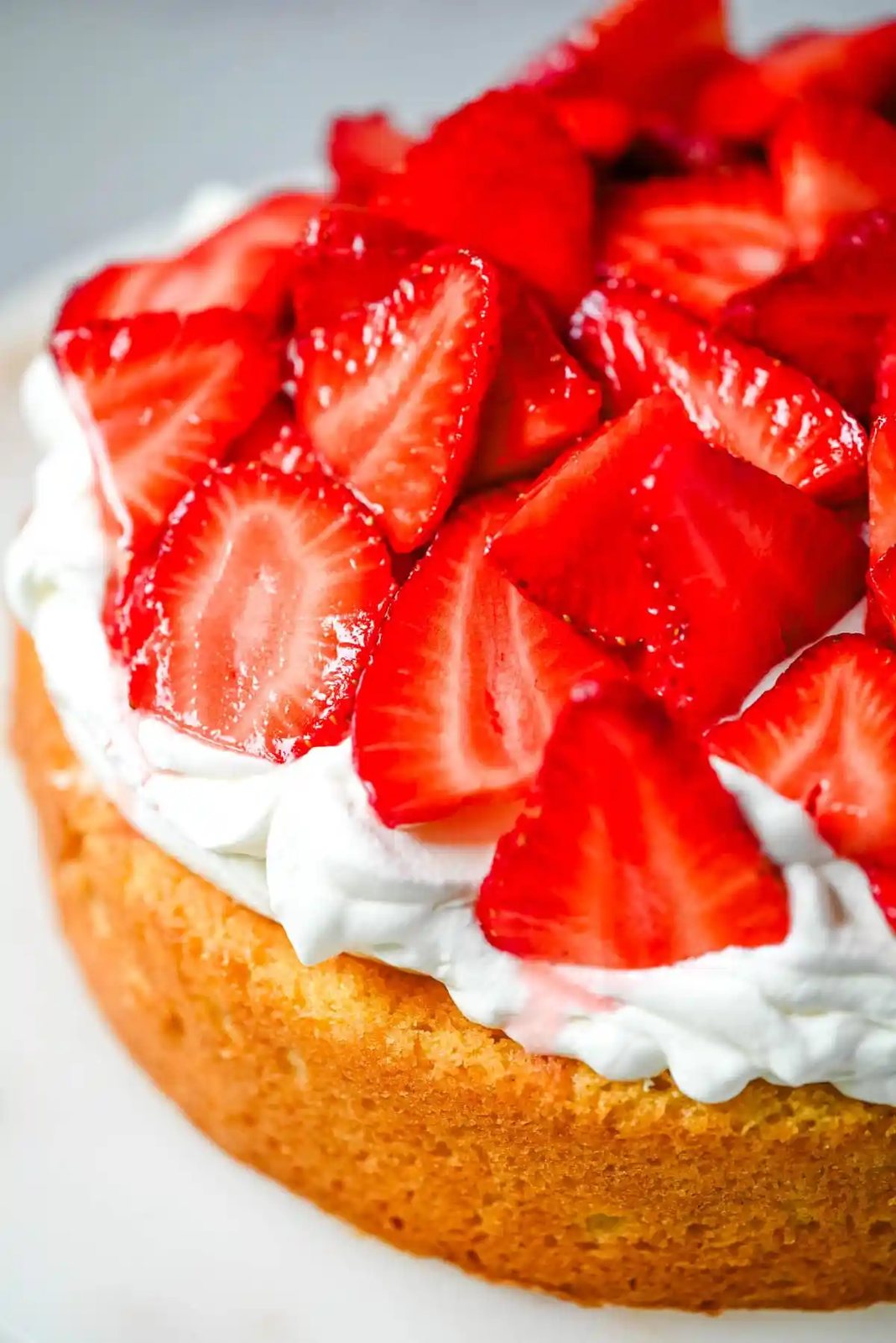 This Strawberry Shortcake Cake is a soft, buttery vanilla cake layered with fluffy homemade whipped cream and juicy strawberries. It’s the perfect spring and summer dessert that tastes like a classic strawberry shortcake but in an easy-to-slice cake form.