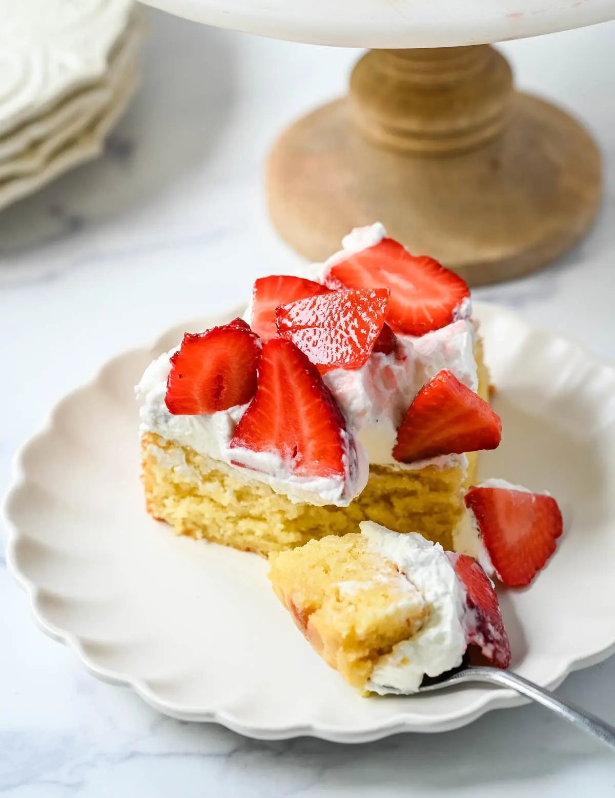 This Strawberry Shortcake Cake is a soft, buttery vanilla cake layered with fluffy homemade whipped cream and juicy strawberries. It’s the perfect spring and summer dessert that tastes like a classic strawberry shortcake but in an easy-to-slice cake form.