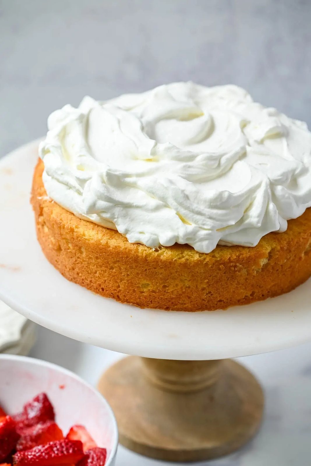 Spread whipped cream all over cake