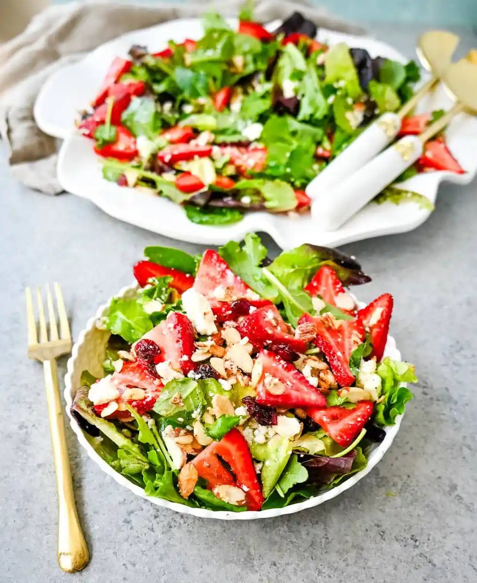 Strawberry Spring Mix Salad. This Strawberry Poppyseed Salad is made with spring mix, fresh strawberries, creamy and tangy feta cheese, sugared almonds, and tossed with a sweet homemade poppyseed dressing.