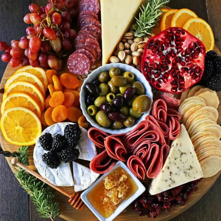 How to make an EPIC Charcuterie Board (AKA Meat and Cheese Platter). How to make a beautiful meat cheese and fruit platter. The perfect appetizer for your next party! www.modernhoney.com #meatboard #meatandcheeseboard #appetizer #appetizers #charcuterieboard #charcuterie #cheeseboard