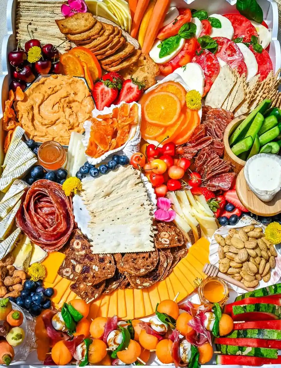 How to make an epic, beautiful Summer Charcuterie Board highlighting all of the fresh fruits and vegetables in season, paired with cheeses and meats perfect for summer. I am sharing all of the ideas on how to create the perfect charcuterie board for summer.