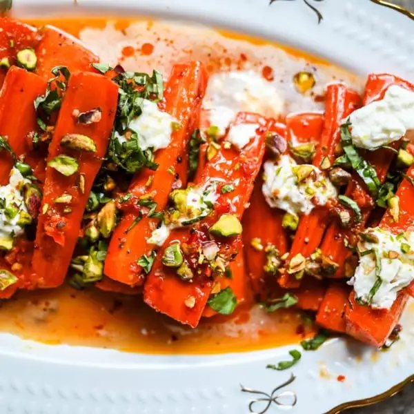 These Sweet and Spicy Roasted Carrots are the perfect combination of sweetness and a warm kick from the Calabrian chili paste. Topped with creamy burrata, crunchy pistachios, and fresh basil, this side dish feels restaurant-worthy but is incredibly easy to make at home. The best roasted carrot side dish recipe!