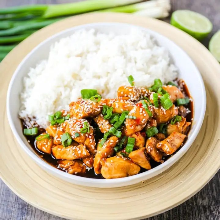 Asian Sticky Chicken Tender chicken sauteed in a sticky sweet and tangy Asian sauce served with creamy coconut rice. A quick and easy 20-minute dinner! www.modernhoney.com #asianfood #chinesefood #stickychicken #chicken