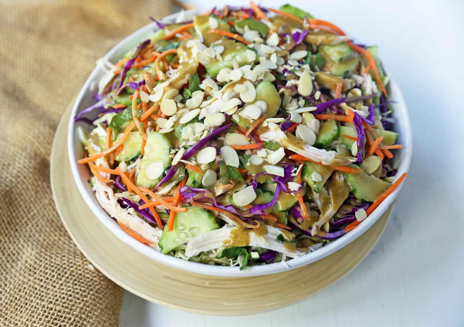 Thai Chicken Salad with Peanut Dressing. Crunchy Thai salad with cabbage, carrots, cucumber, slivered almonds, tender chicken in a homemade peanut dressing. A flavorful Chinese Chicken Salad. www.modernhoney.com #asiansalad #chickensalad #thaichickensalad #chinesechickensalad