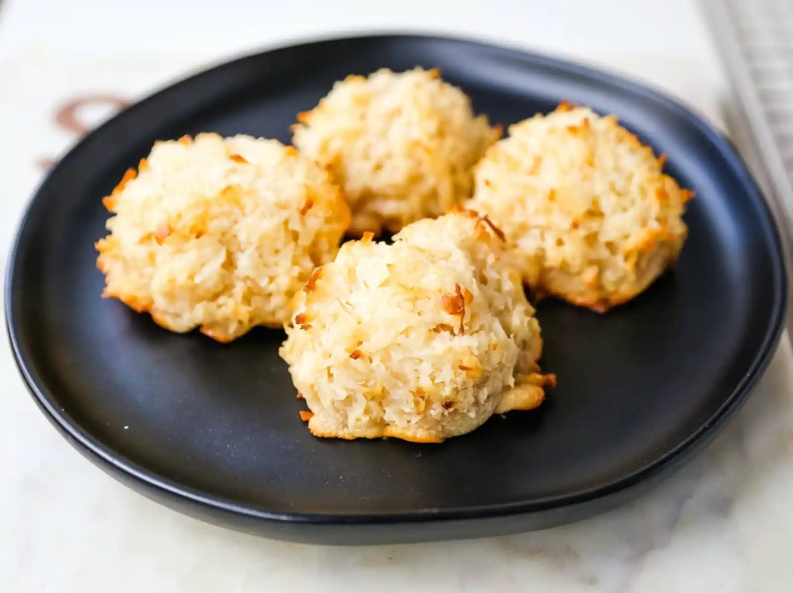 The Best Coconut Macaroons. Soft chewy sweet coconut macaroons are the perfect gluten-free cookie. How to make the perfect coconut macaroons dipped in dark chocolate. www.modernhoney.com #macaroons #coconutmacaroons #macaroon #christmascookie #christmascookies