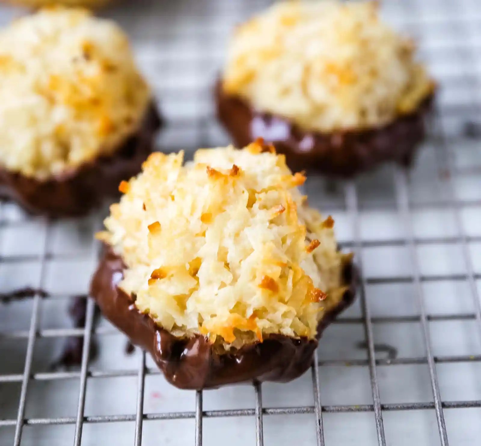 The Best Coconut Macaroons. Soft chewy sweet coconut macaroons are the perfect gluten-free cookie. How to make the perfect coconut macaroons dipped in dark chocolate. www.modernhoney.com #macaroons #coconutmacaroons #macaroon #christmascookie #christmascookies