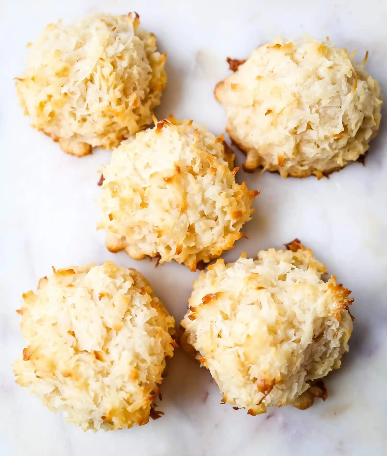 The Best Coconut Macaroons. Soft chewy sweet coconut macaroons are the perfect gluten-free cookie. How to make the perfect coconut macaroons dipped in dark chocolate. www.modernhoney.com #macaroons #coconutmacaroons #macaroon #christmascookie #christmascookies