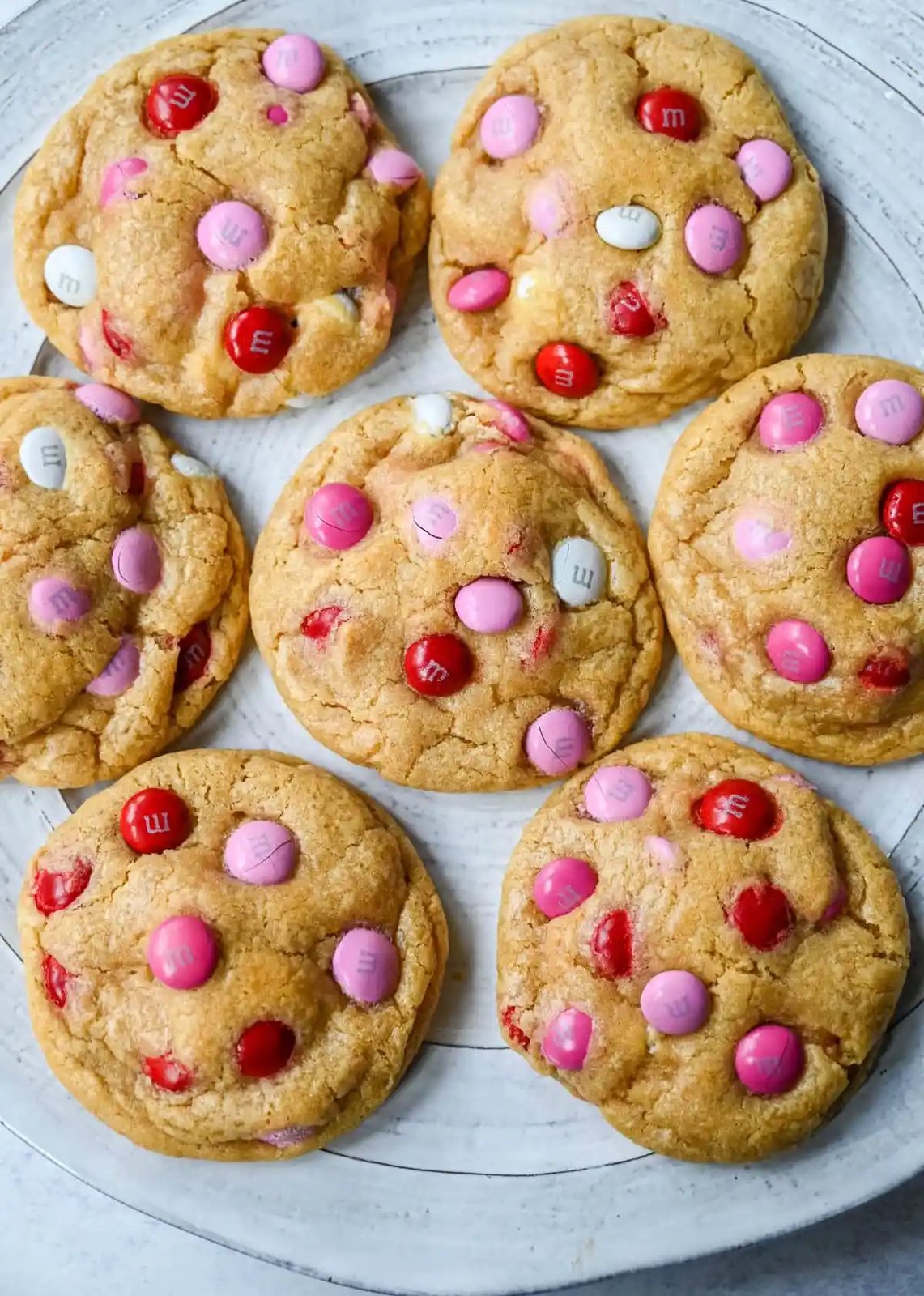 How to make the perfect Valentine's Day cookies. These soft and chewy Valentine's M&M Cookies have pops of pink, red, and white M&M's to make them not only delicious but festive and fun as well. You will love these Valentine's cookies!