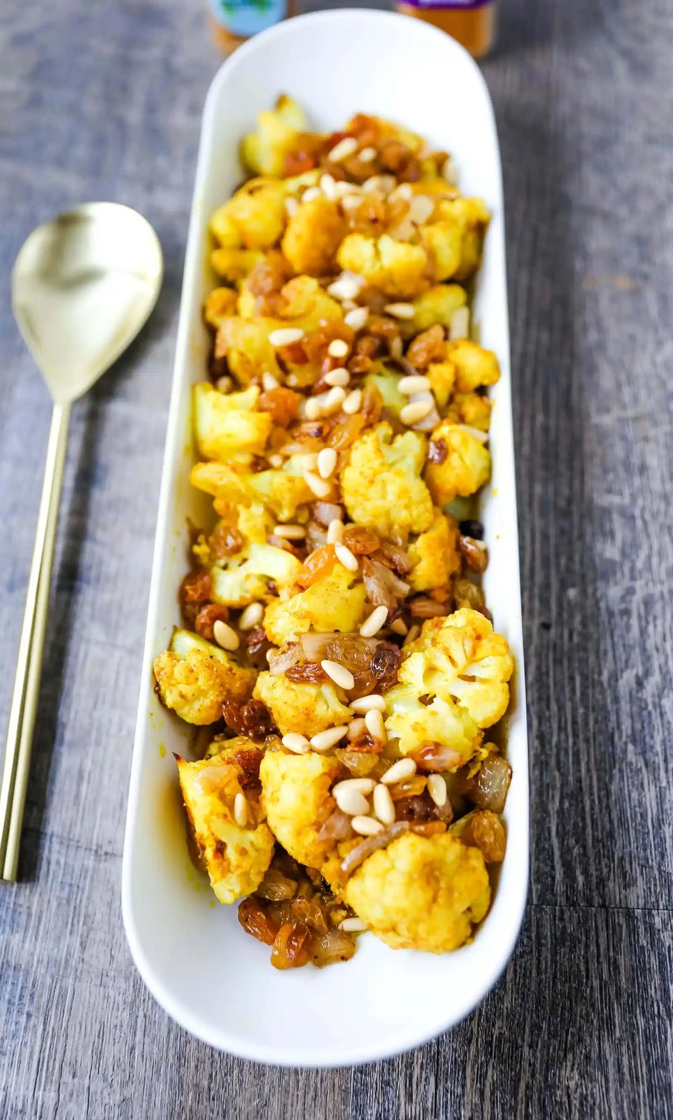 Turmeric Roasted Cauliflower Indian spiced roasted cauliflower with warm spices, caramelized onions, sweet golden raisins, and crunchy pine nuts. A flavorful, healthy side dish perfect for any occasion! www.modernhoney.com #cauliflower #sidedish #roastedvegetables #indianfood