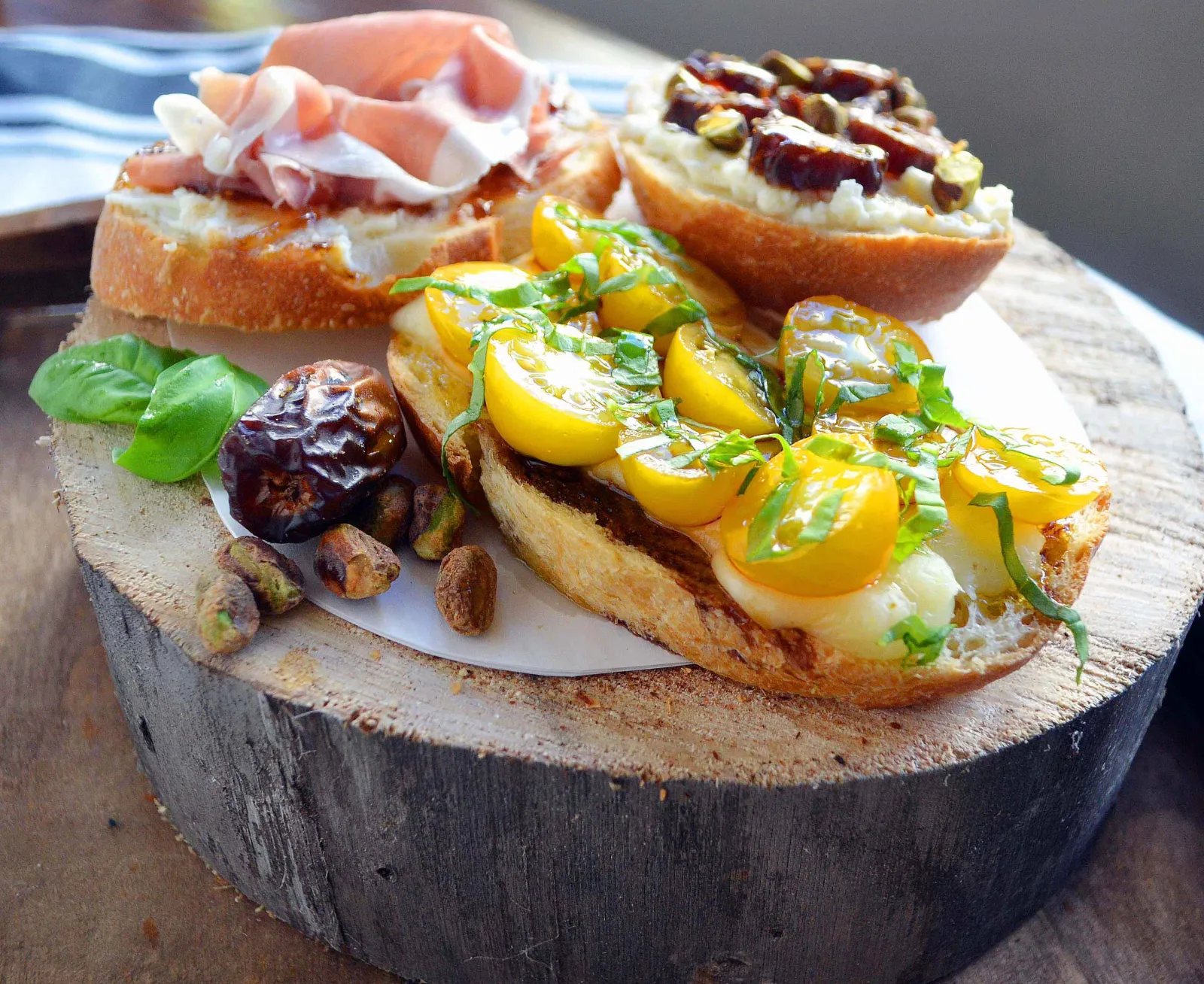 Ultimate Bruschetta Bar by Modern Honey. How to make a perfect bruschetta or charcuterie board using fresh meats, cheeses, fruits, breads, nuts, roasted vegetables, and fresh herbs. It's the perfect party appetizer. Bruschetta topping ideas plus flavor combinations.