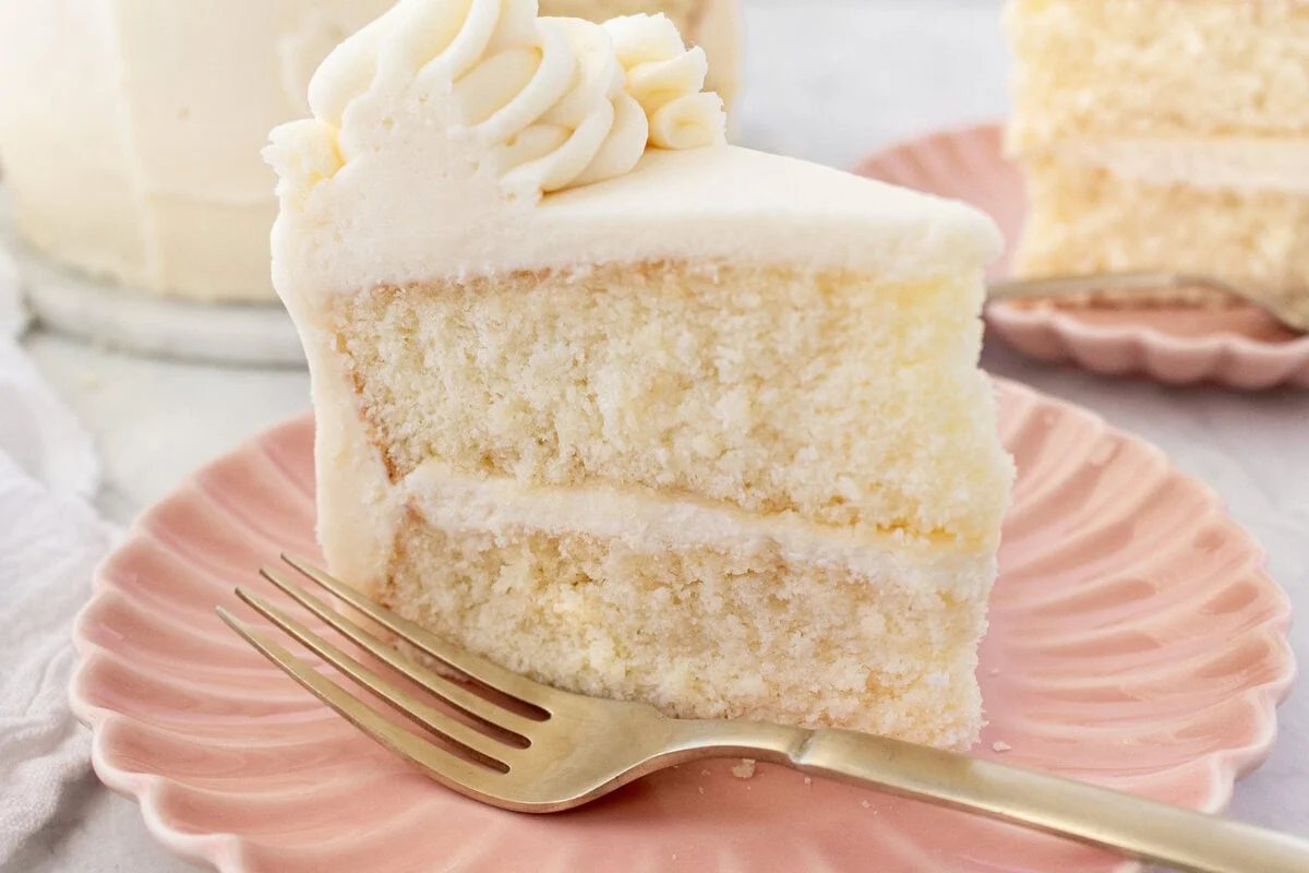 The best homemade vanilla cake recipe with vanilla bean buttercream frosting. If you’re looking for the best homemade vanilla cake recipe, this is it! This moist and fluffy vanilla cake is easy to make from scratch using simple ingredients. Perfect for birthdays or celebrations. This white cake recipe features a light, airy crumb and the most tender texture. This is a bakery-worthy dessert!