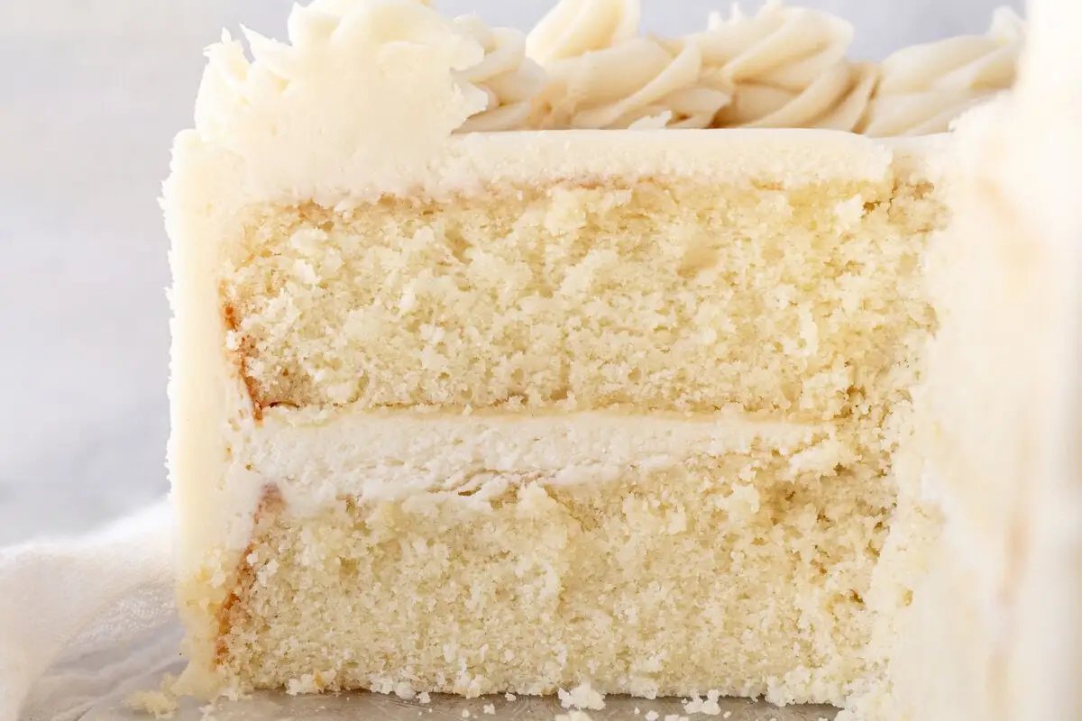 The best homemade vanilla cake recipe with vanilla bean buttercream frosting. If you’re looking for the best homemade vanilla cake recipe, this is it! This moist and fluffy vanilla cake is easy to make from scratch using simple ingredients. Perfect for birthdays or celebrations. This white cake recipe features a light, airy crumb and the most tender texture. This is a bakery-worthy dessert!