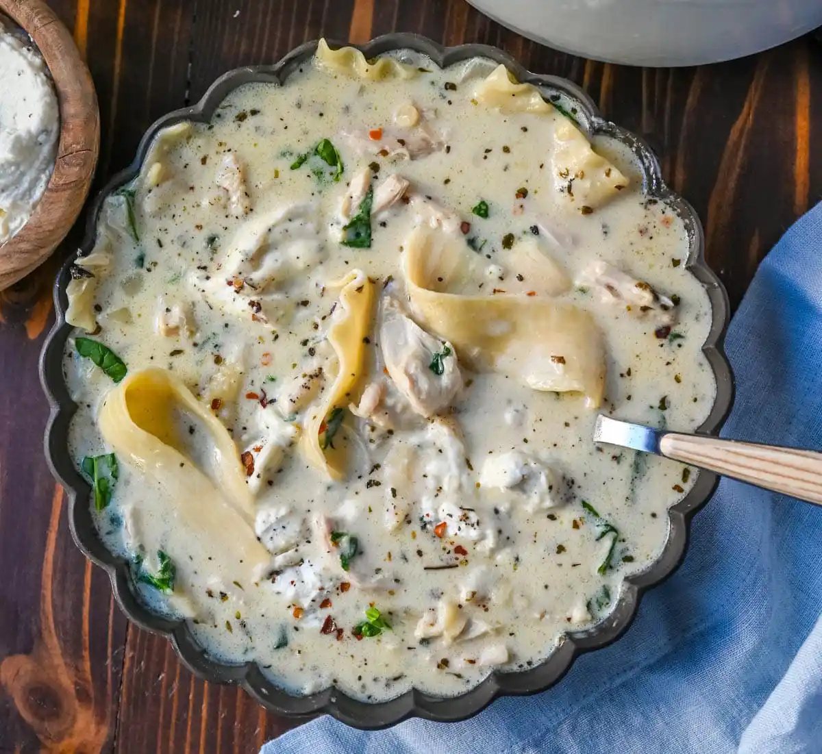 This White Chicken Lasagna Soup is everything you love about a creamy, cheesy chicken lasagna, without all the layering! Lasagna noodles, tender shredded chicken, and spinach all simmer together in one pot in a garlicky parmesan cream broth. Then you top each bowl with a dollop of herbed ricotta.