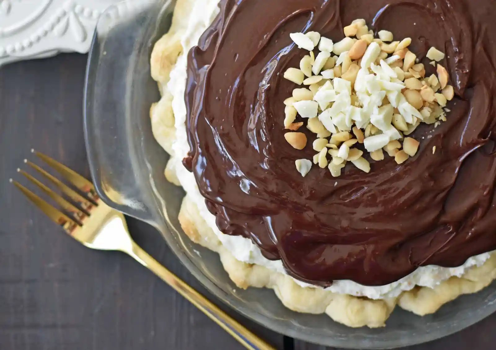White Chocolate Macadamia Pie made with a fluffy white chocolate cream filling studded with orange zest and macadamia nuts and topped with a silky smooth chocolate ganache and freshly whipped cream. White Chocolate Orange Chocolate Ganache Pie. The BEST PIE ever! www.modernhoney.com