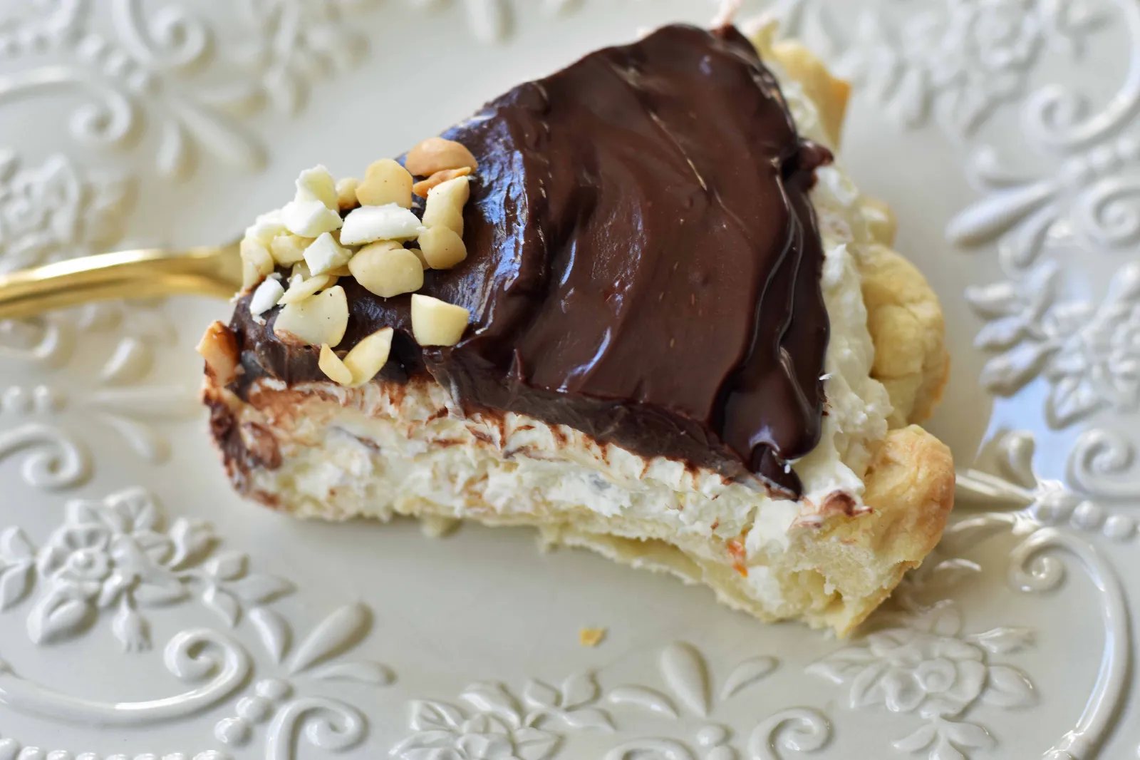 White Chocolate Macadamia Pie made with a fluffy white chocolate cream filling studded with orange zest and macadamia nuts and topped with a silky smooth chocolate ganache and freshly whipped cream. White Chocolate Orange Chocolate Ganache Pie. The BEST PIE ever! www.modernhoney.com