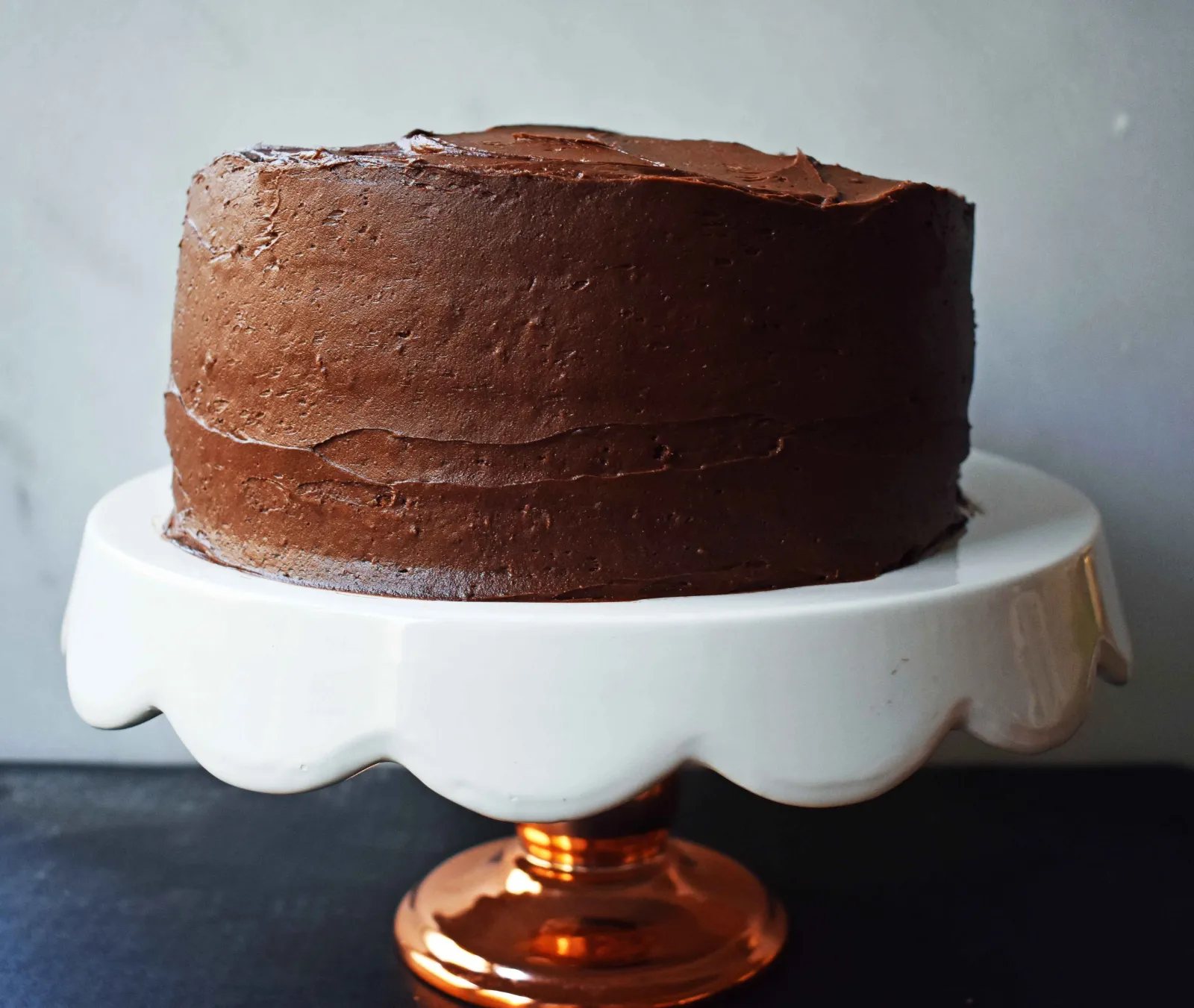 Yellow Birthday Cake with Milk Chocolate Frosting by Modern Honey. Homemade Yellow Cake with Vanilla Pudding Mix to make it extra moist and flavorful. Rich chocolate buttercream is the perfect addition to this birthday cake.