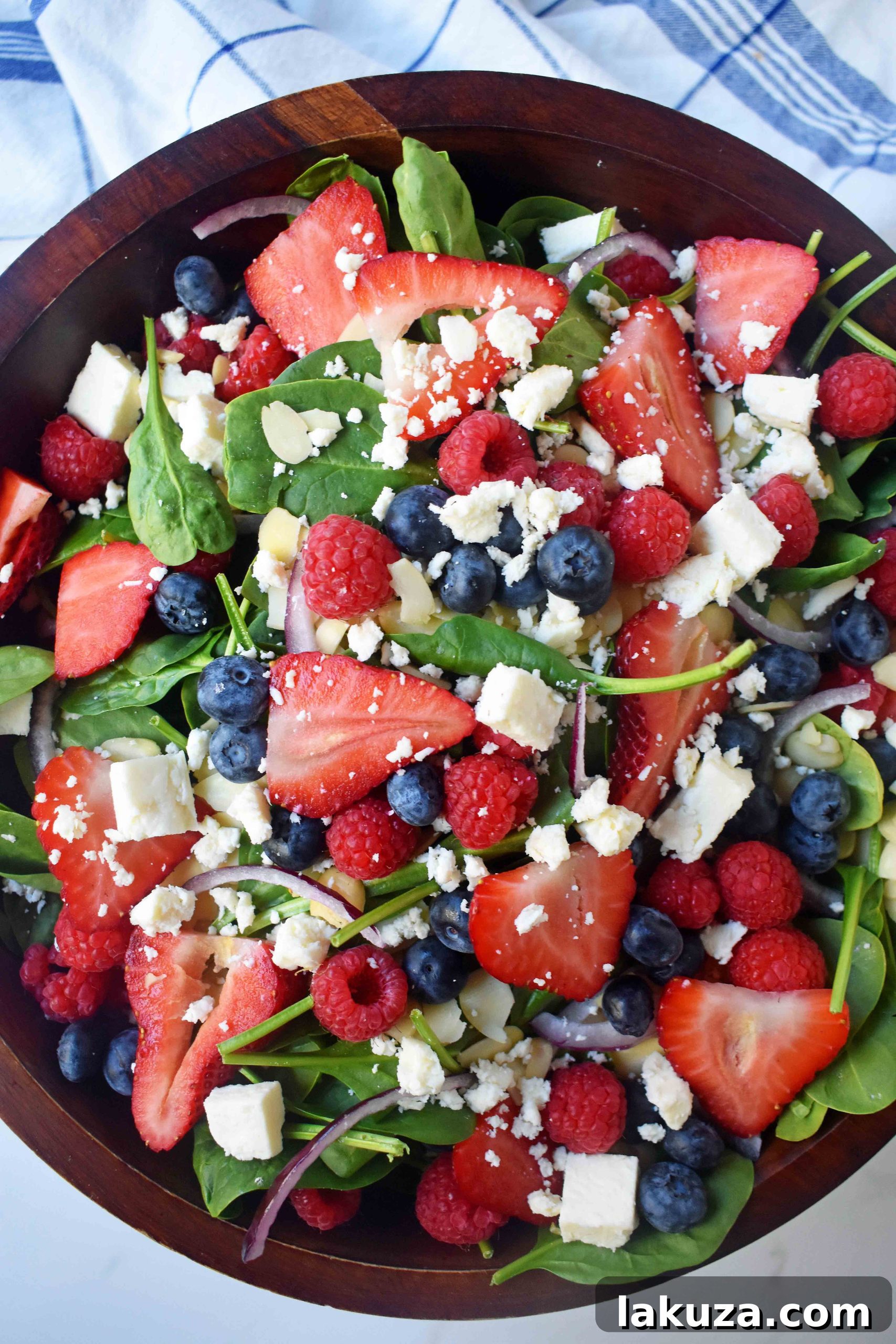 Sweet Poppy Seed Dressed Spinach Berry Salad 3 Spinach Berry Salad with Sweet Poppyseed Dressing. Fresh Spinach Salad with Berries, Feta Cheese, and Poppy Seed Dressing. Close-up of salad components.