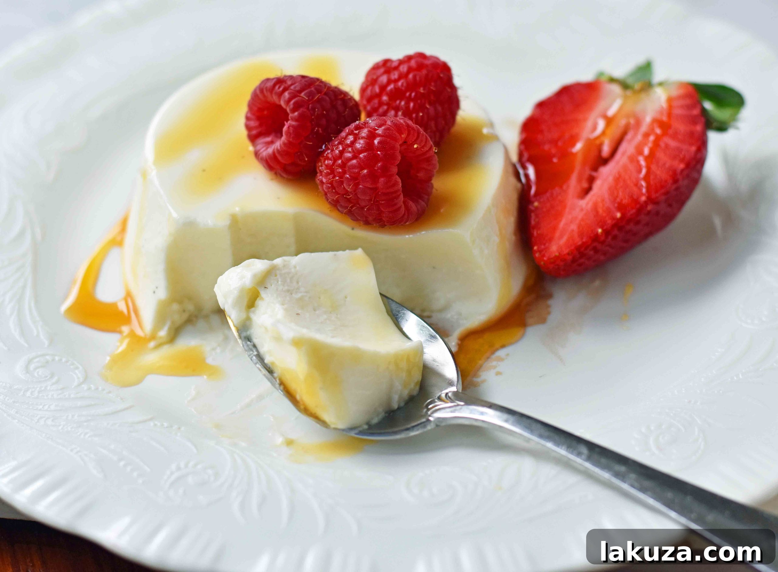 Tangy Greek Yogurt Panna Cotta 10 Nine servings of Greek Yogurt Panna Cotta arranged beautifully, some topped with fresh berries, showcasing the versatility and visual appeal of this creamy, easy-to-make dessert.