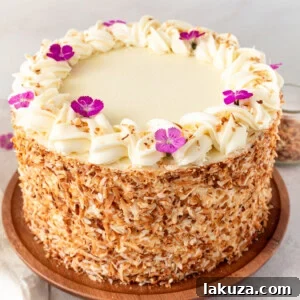 This homemade, moist coconut cake with coconut cream cheese frosting is the best coconut cake recipe. It is made with sweet cream butter, coconut milk, buttermilk, coconut pudding mix, and cake flour to make it extra tender. The coconut cream cheese frosting puts it over the top!