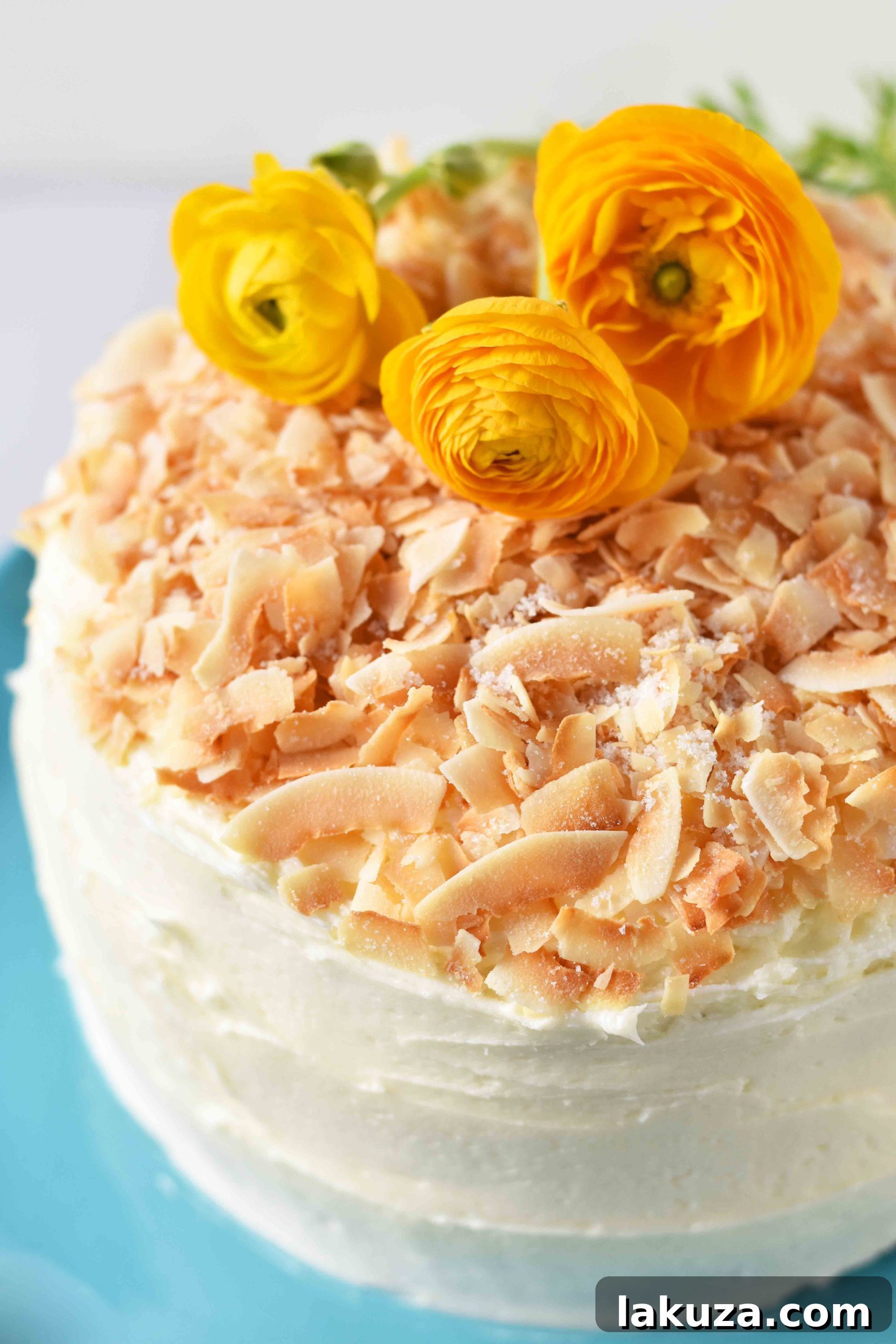 A grand, multi-tiered coconut cake, expertly frosted and decorated, standing as a centerpiece. This best coconut cake recipe offers ultimate indulgence for any celebration.