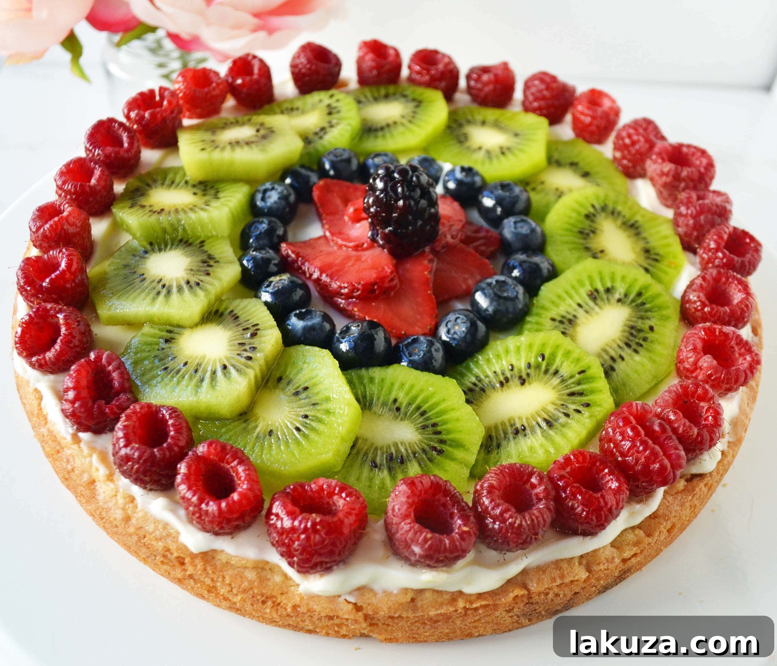 Close-up of a slice of White Chocolate Macadamia Fruit Pizza Tart, showcasing its layers and fresh fruit topping.