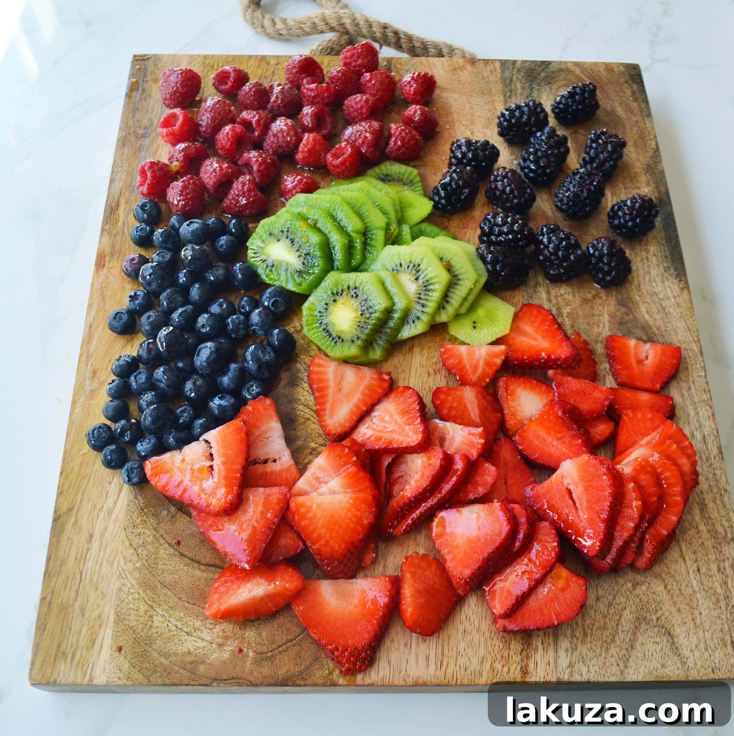 White Chocolate Macadamia Fruit Pizza Tart, showing a generous layer of cream cheese and various fruits.