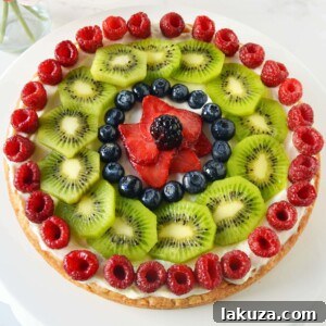 White Chocolate Macadamia Fruit Pizza Tart by Modern Honey. A delicious blend of cookie and fresh fruit.