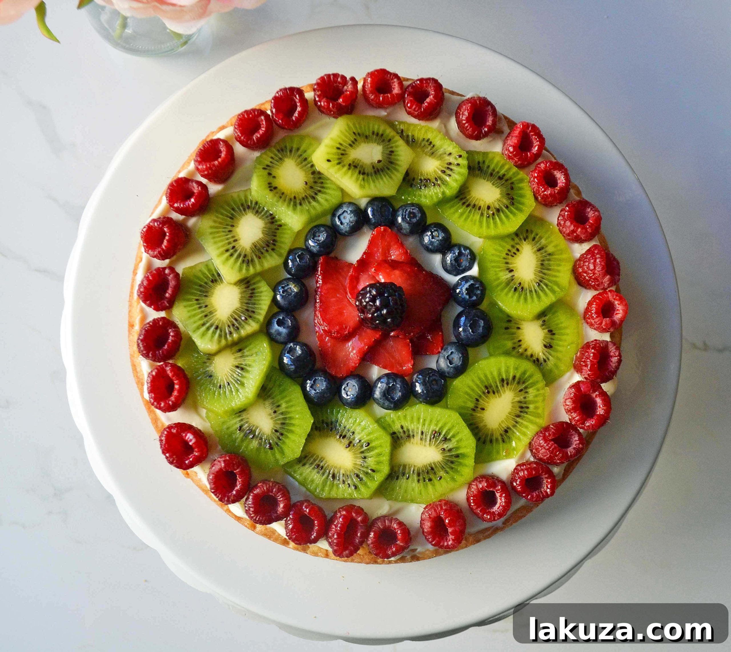 A vibrant and fresh White Chocolate Macadamia Fruit Pizza Tart, perfect for special occasions.