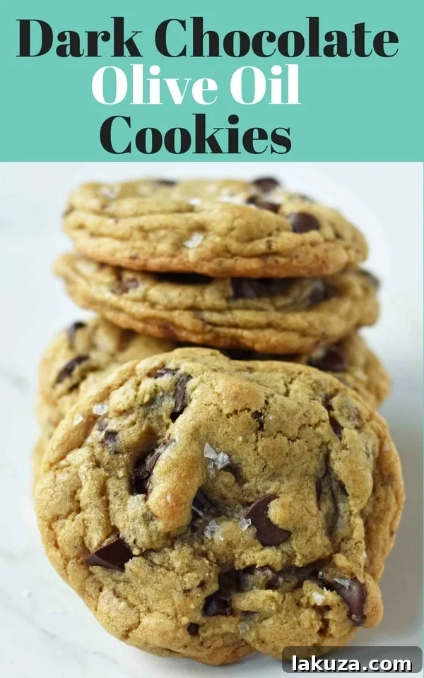 Rich Dark Chocolate Olive Oil Cookies 8 A stack of gourmet Dark Chocolate Chunk Olive Oil Cookies, glistening with sea salt flakes, ready to be enjoyed.