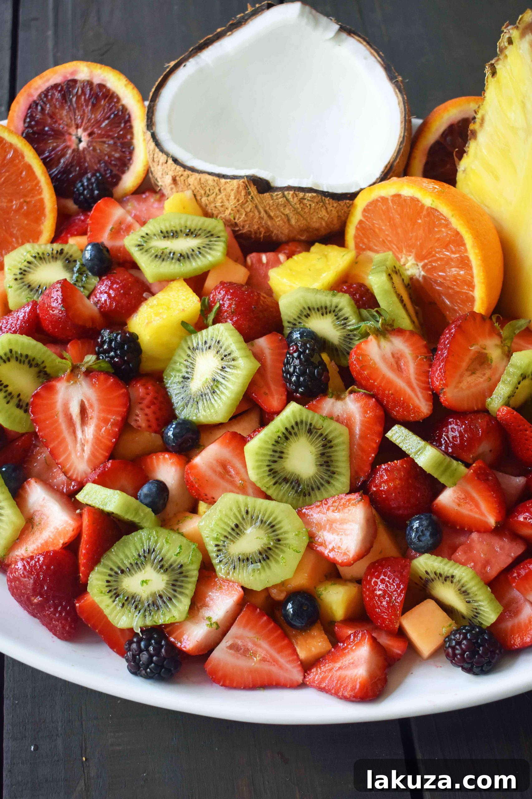 Summer Fruit Salad with Honey Lime Dressing. A healthy side dish! Vibrant fresh fruit with a citrus orange lime honey dressing. www.modernhoney.com