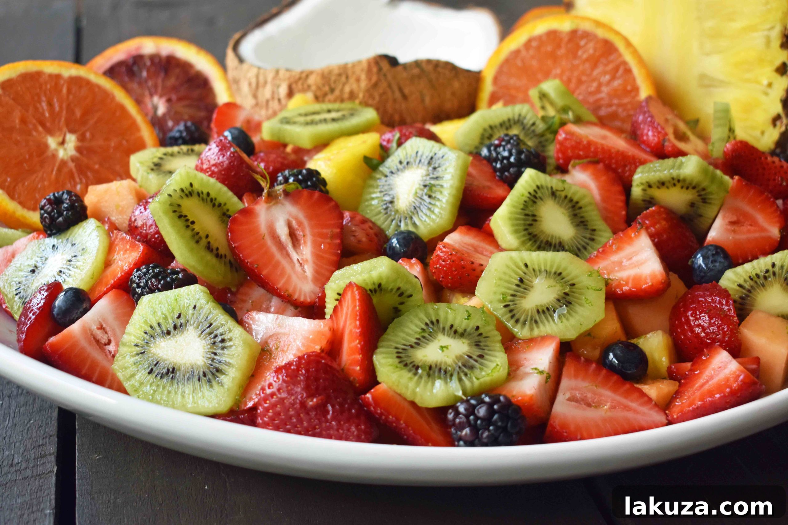 Summer Fruit Salad with Honey Lime Dressing. A healthy side dish! Vibrant fresh fruit with a citrus orange lime honey dressing. www.modernhoney.com
