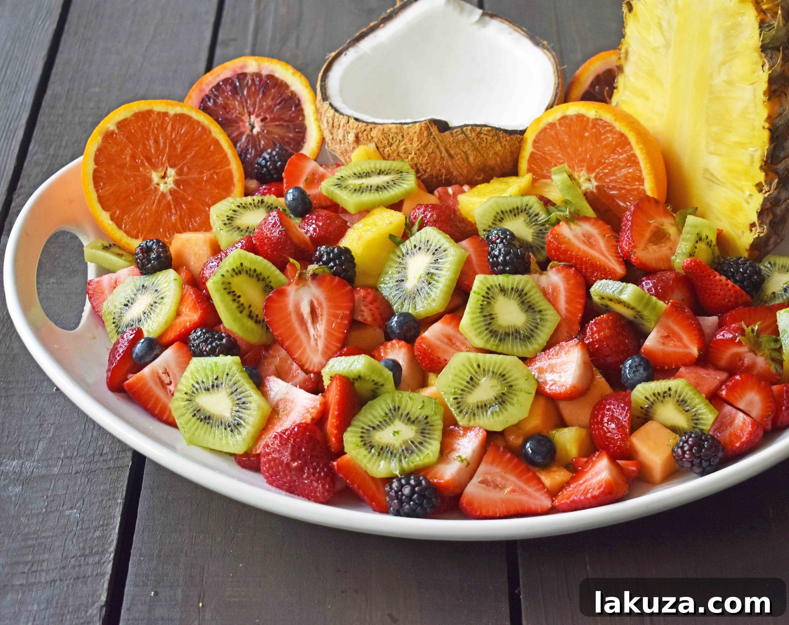 Summer Fruit Salad with Honey Lime Dressing. A healthy side dish! Vibrant fresh fruit with a citrus orange lime honey dressing. www.modernhoney.com